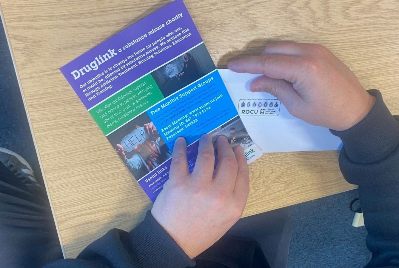 A Druglink leaflet being put into an ERSOU envelope