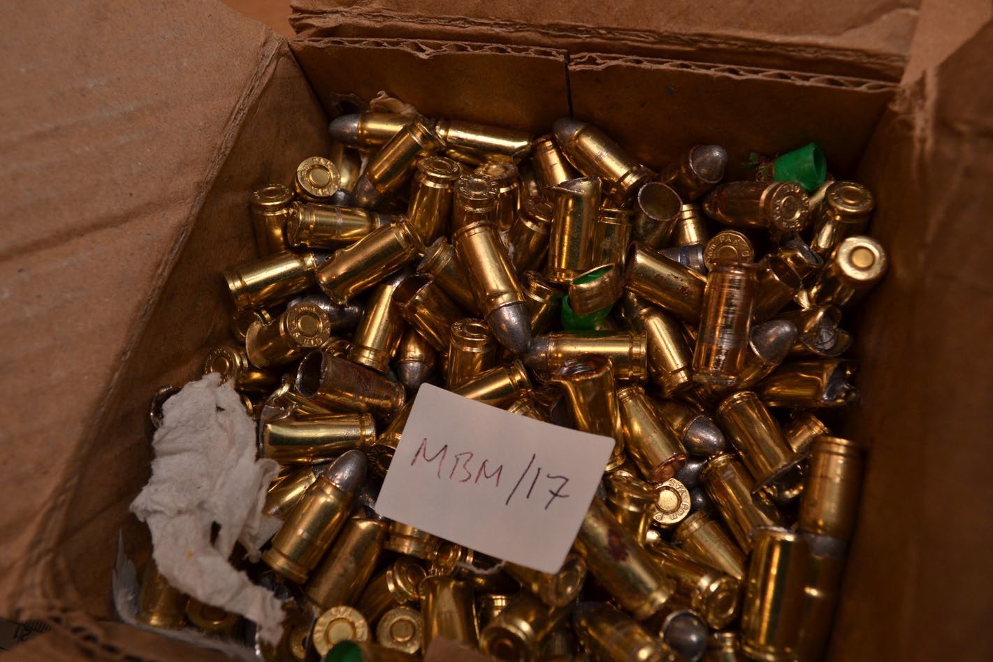 Gold coloured bullet casings in a box