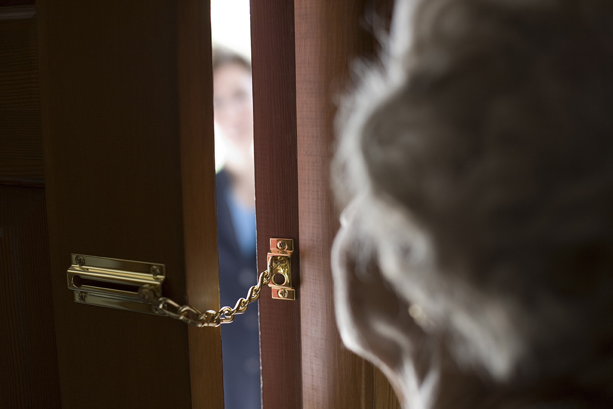 Elderly woman at the door with unknown cold caller